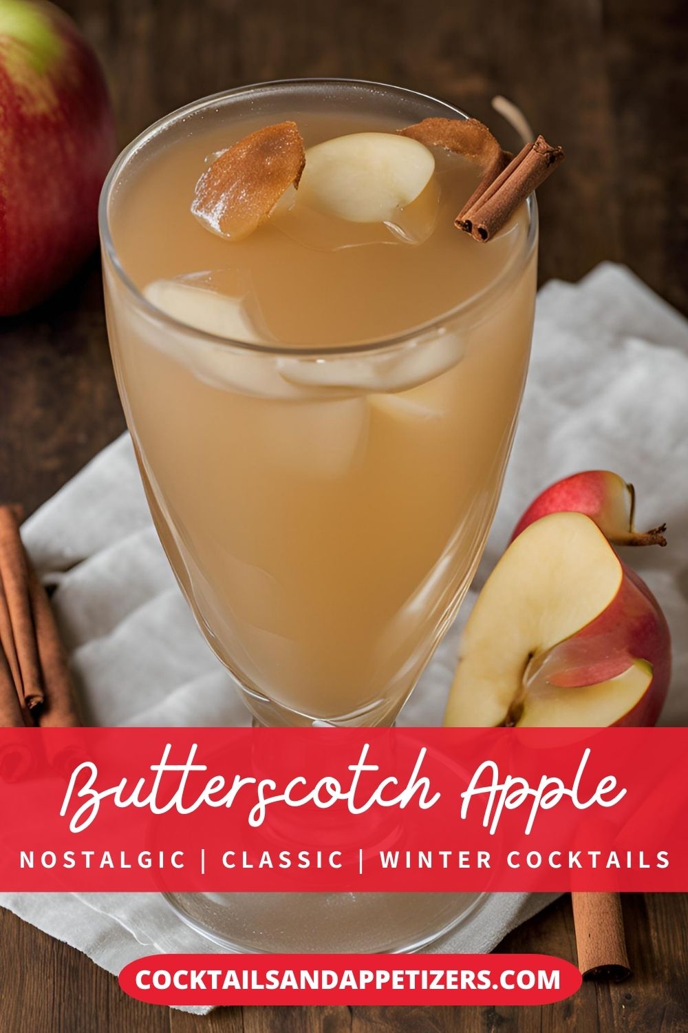 A Butterscotch Schnapps Apple drink in a highball glass with ice and apple slice garnish sit on a table.