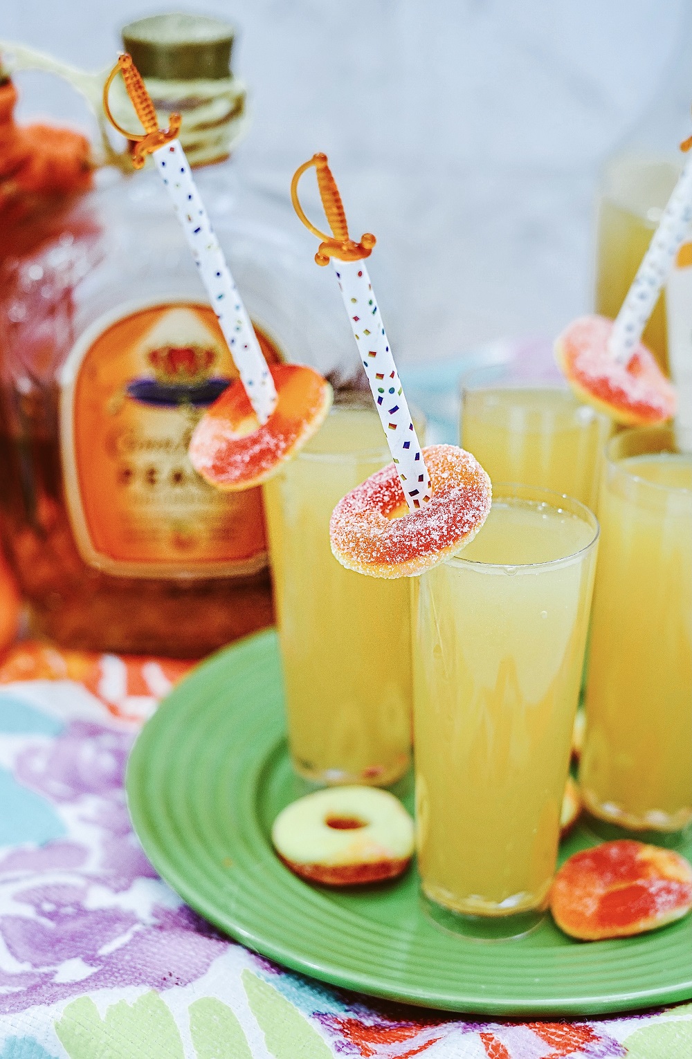 Crown Royal Peach Shooters with a peach ring for garnish.