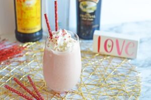 Strawberry mudslide cocktail topped with whipping cream