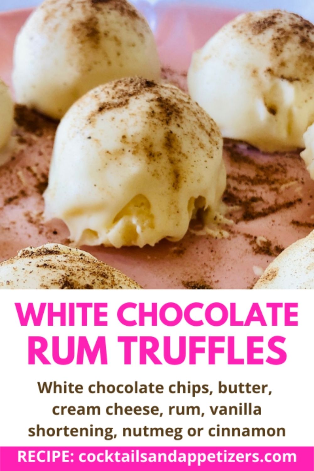 White chocolate rum truffles on a pink plate.