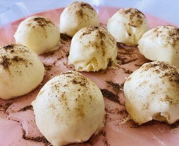 white chocolate rum truffles on a pink plate