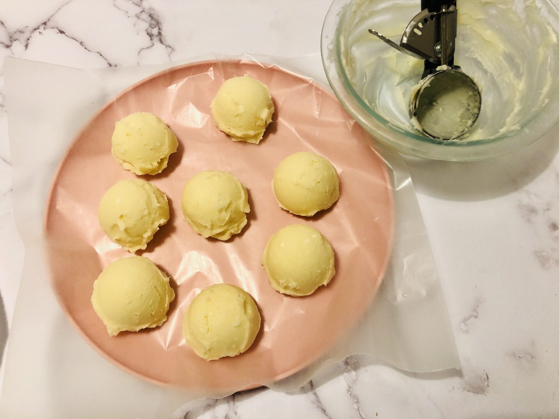 Form white chocolate rum truffles using a cookie scoop.