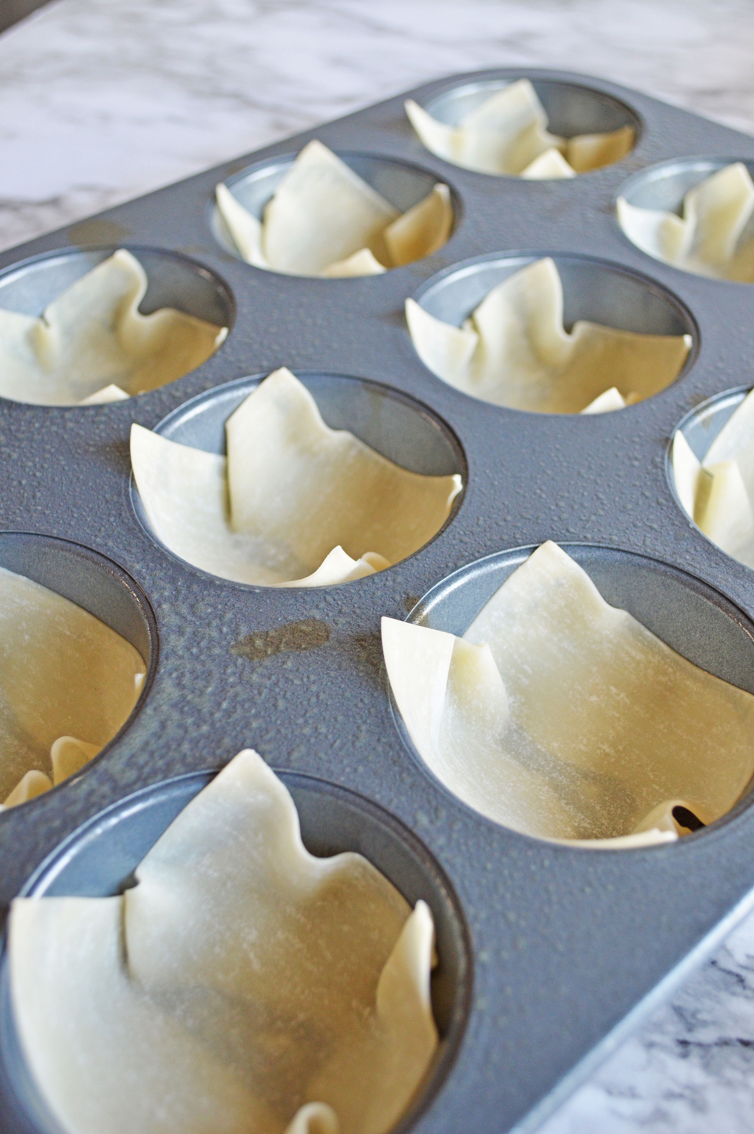 won ton wrappers lining muffin cups