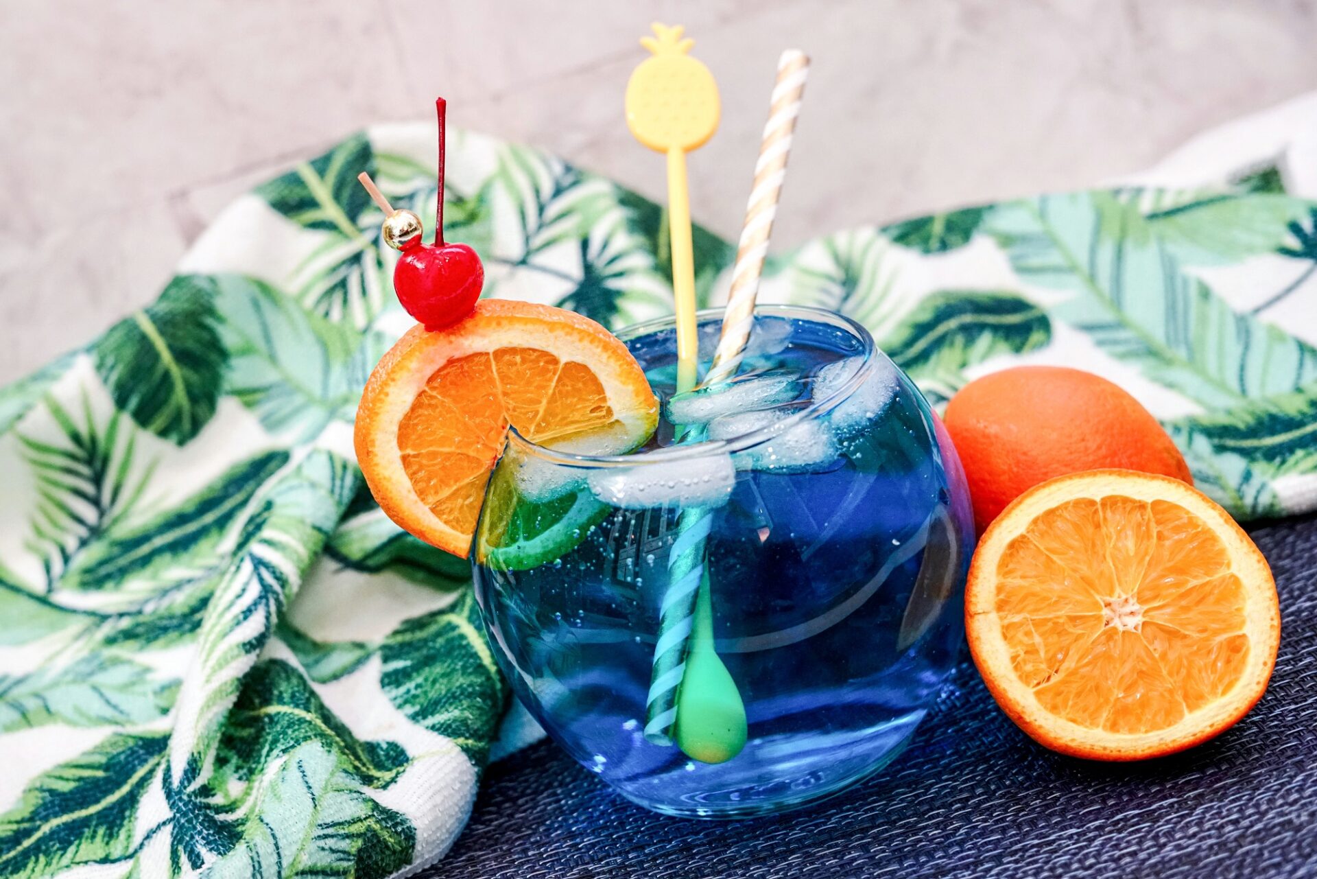 Blue Lagoon Cocktail on a counter with half an orange.