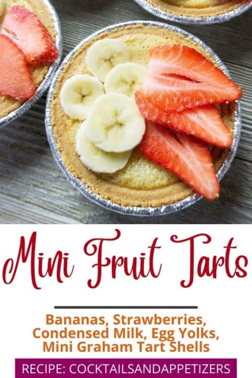 Mini fruit tarts sit on a wood table.