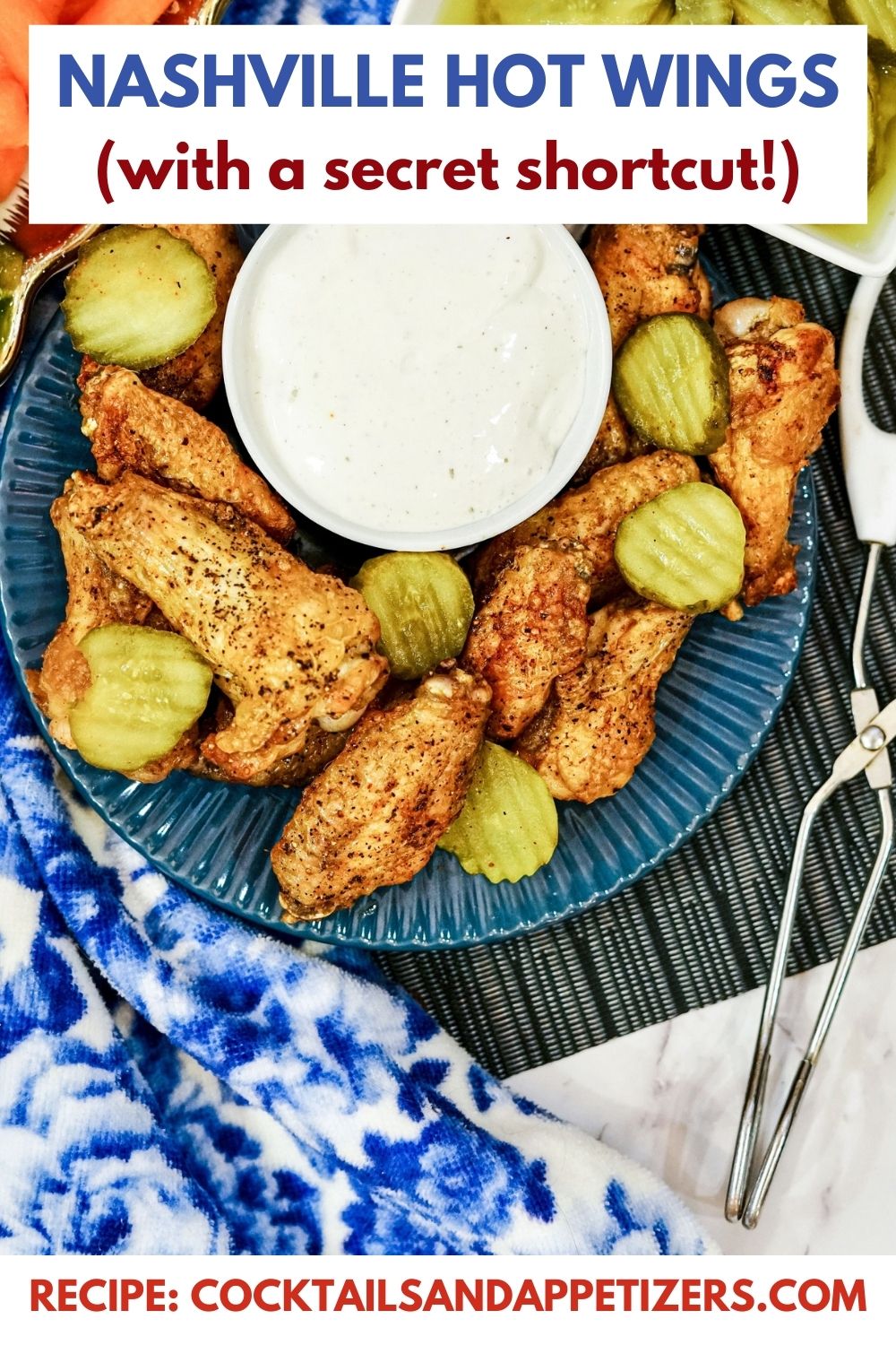 Nashville hot wings with pickles and dip on a blue plate.