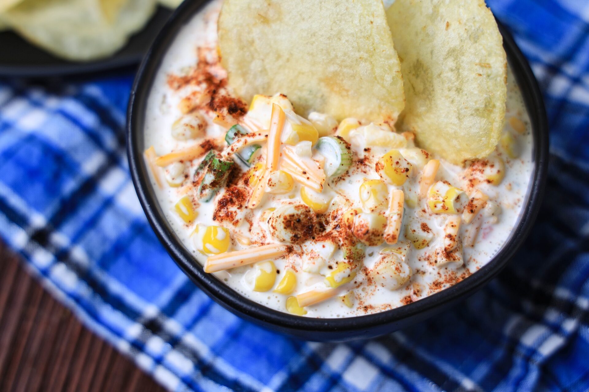 southwestern corn dip in a bowl with potato chips