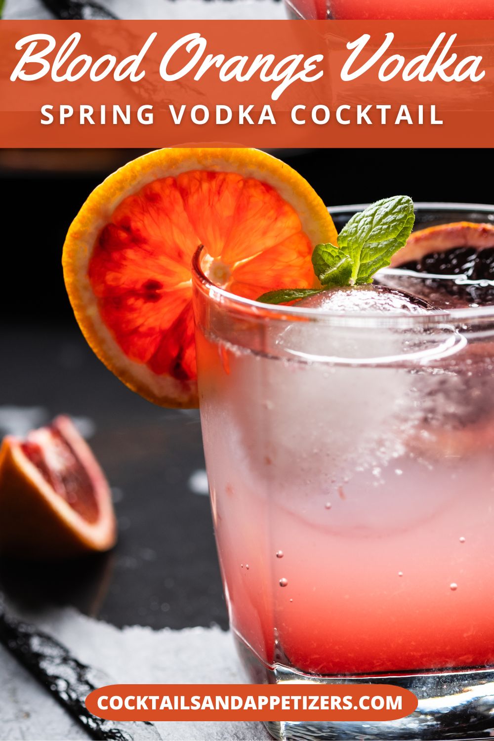 A blood orange and vodka cocktail in a highball glass, garnished with fresh blood orange slices.