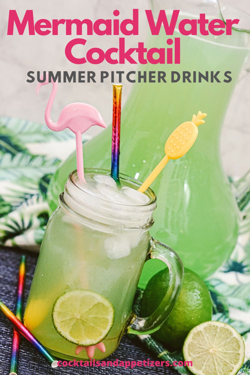 A jug of Mermaid Water sits on a colorful table, alongside a mason jar of Mermaid Water, garnished with straws and stir sticks.