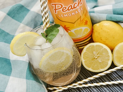 Peach Lemonade Vodka Seltzer in a glass with lemon garnish