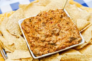 taco dip recipe with ground beef in a bowl