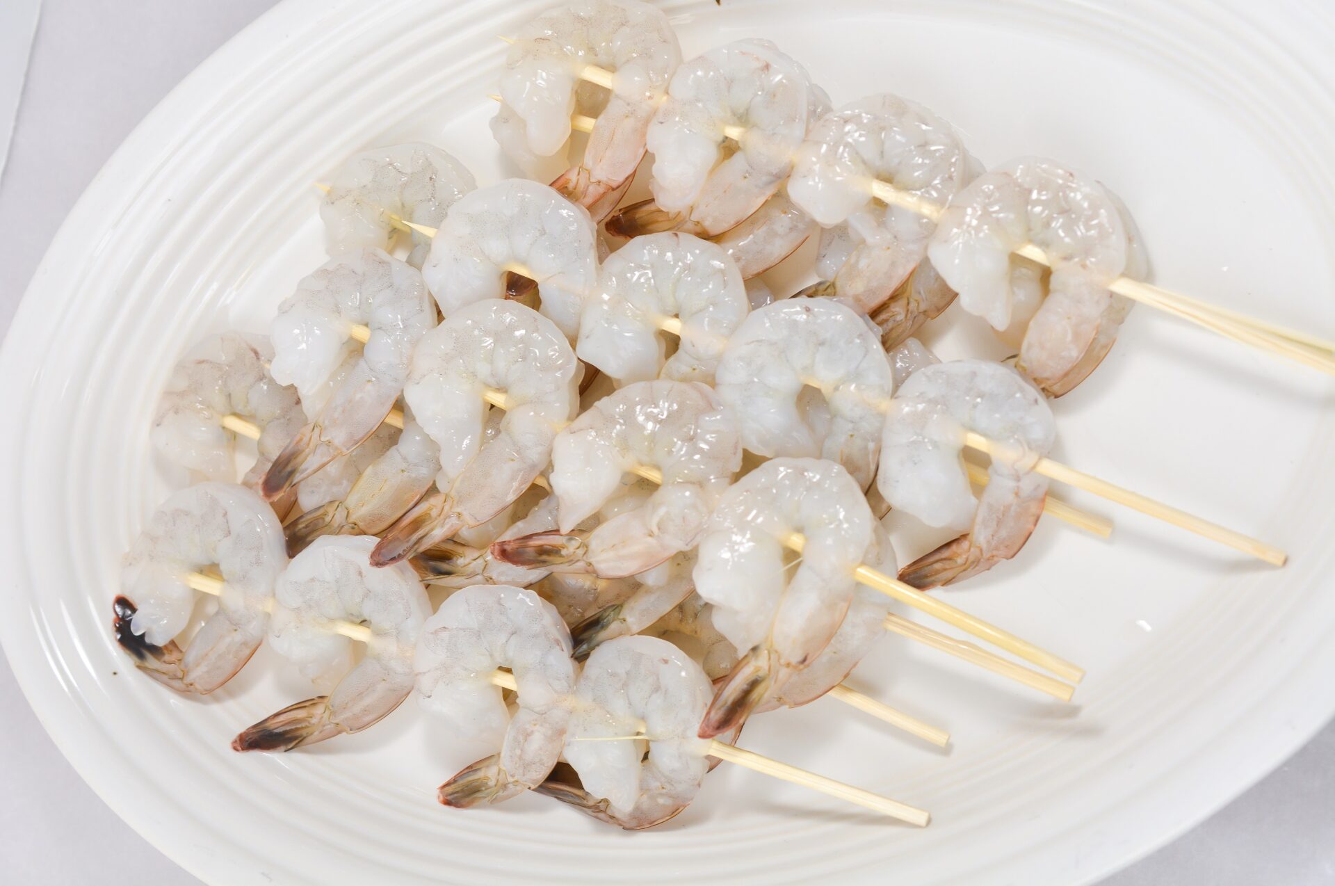 Raw shrimp on skewers for Bang Bang Shrimp