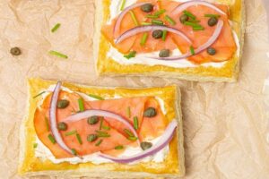 Smoked Salmon Puff Pastry with cream cheese and capers on a tray