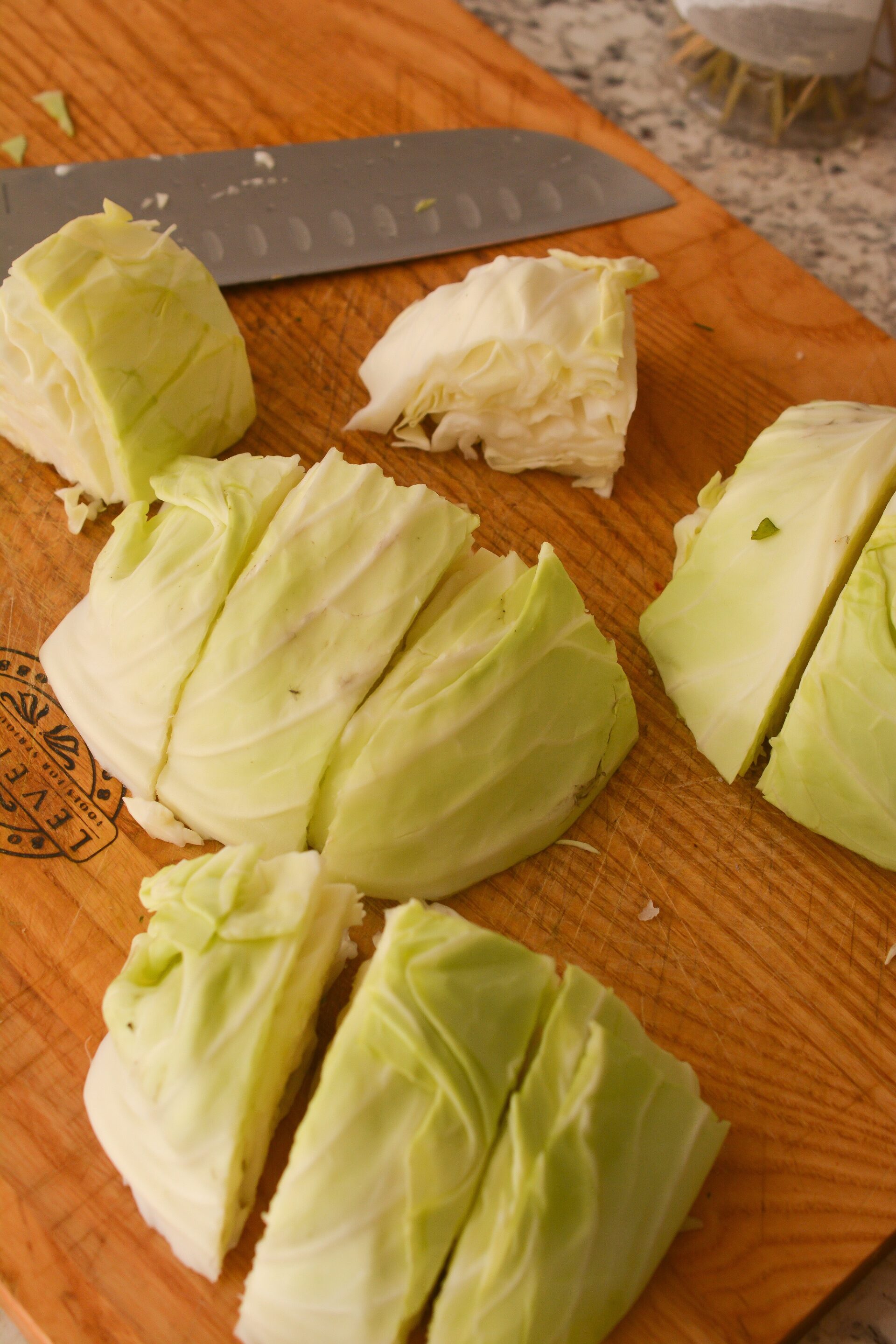 Sliced cabbage wedges on a table.