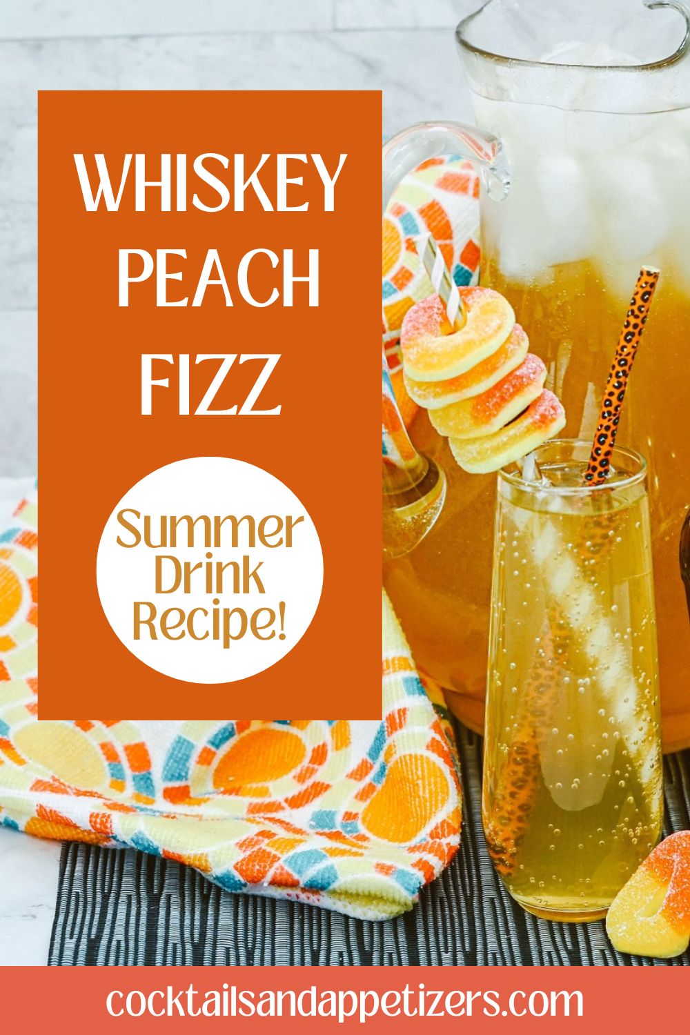 Whiskey Peach Fizz in champagne glass with peach candy garnish