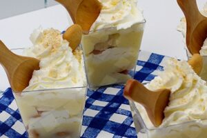 Banana Pudding Cups with wooden spoons on a blue checkered cloth