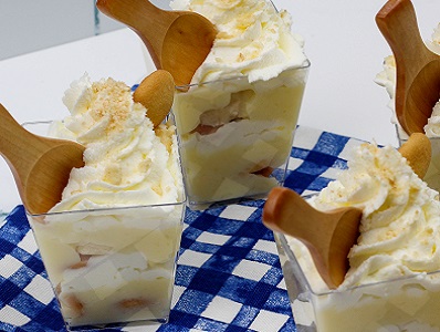 Banana Pudding Cups with wooden spoons on a blue checkered cloth