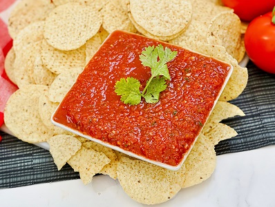 Chili's Copycat Salsa in a serving dish with tortilla chips around it