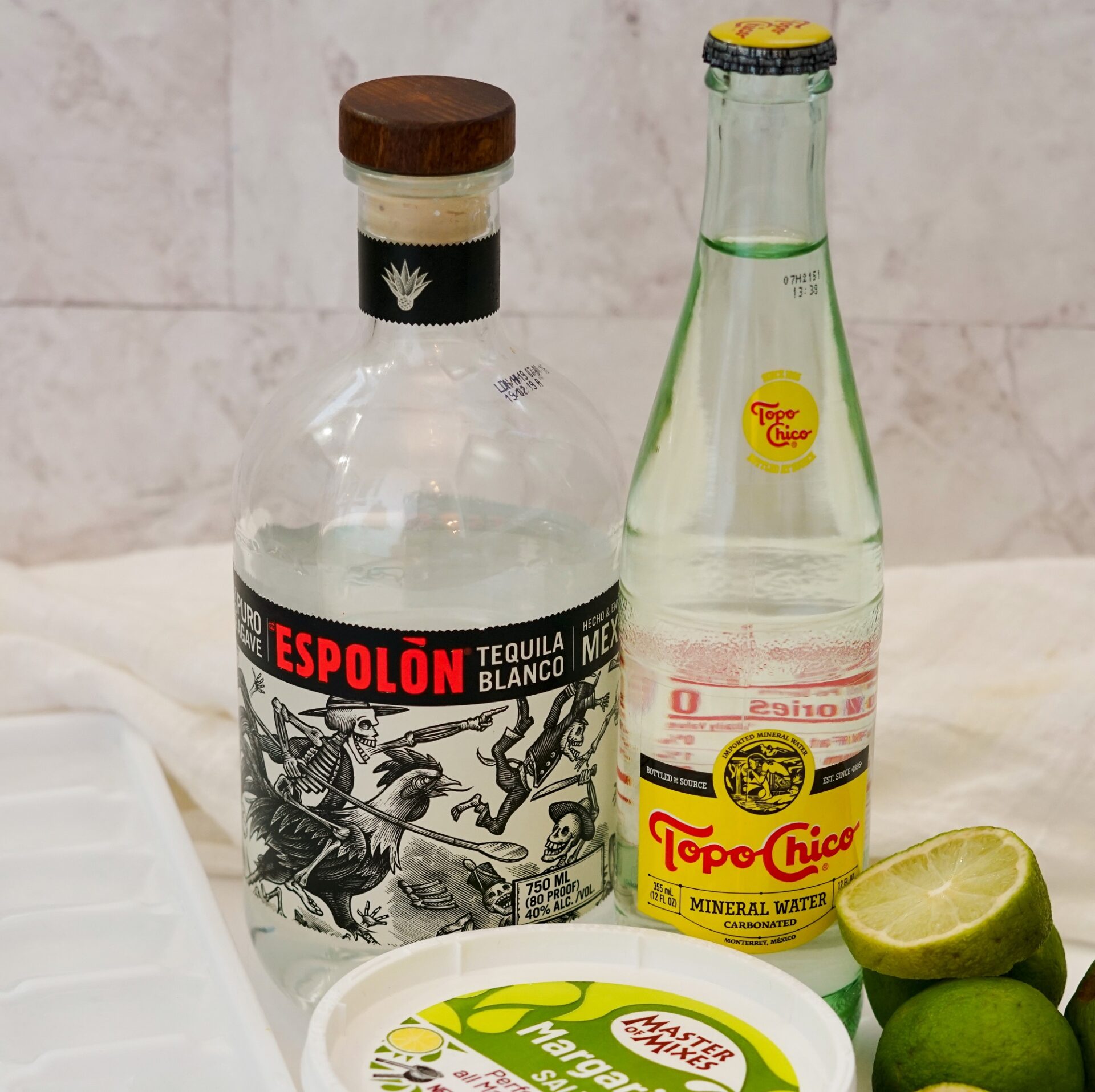 Bottle of Espolòn blanco tequila with Topo Chico mineral water.