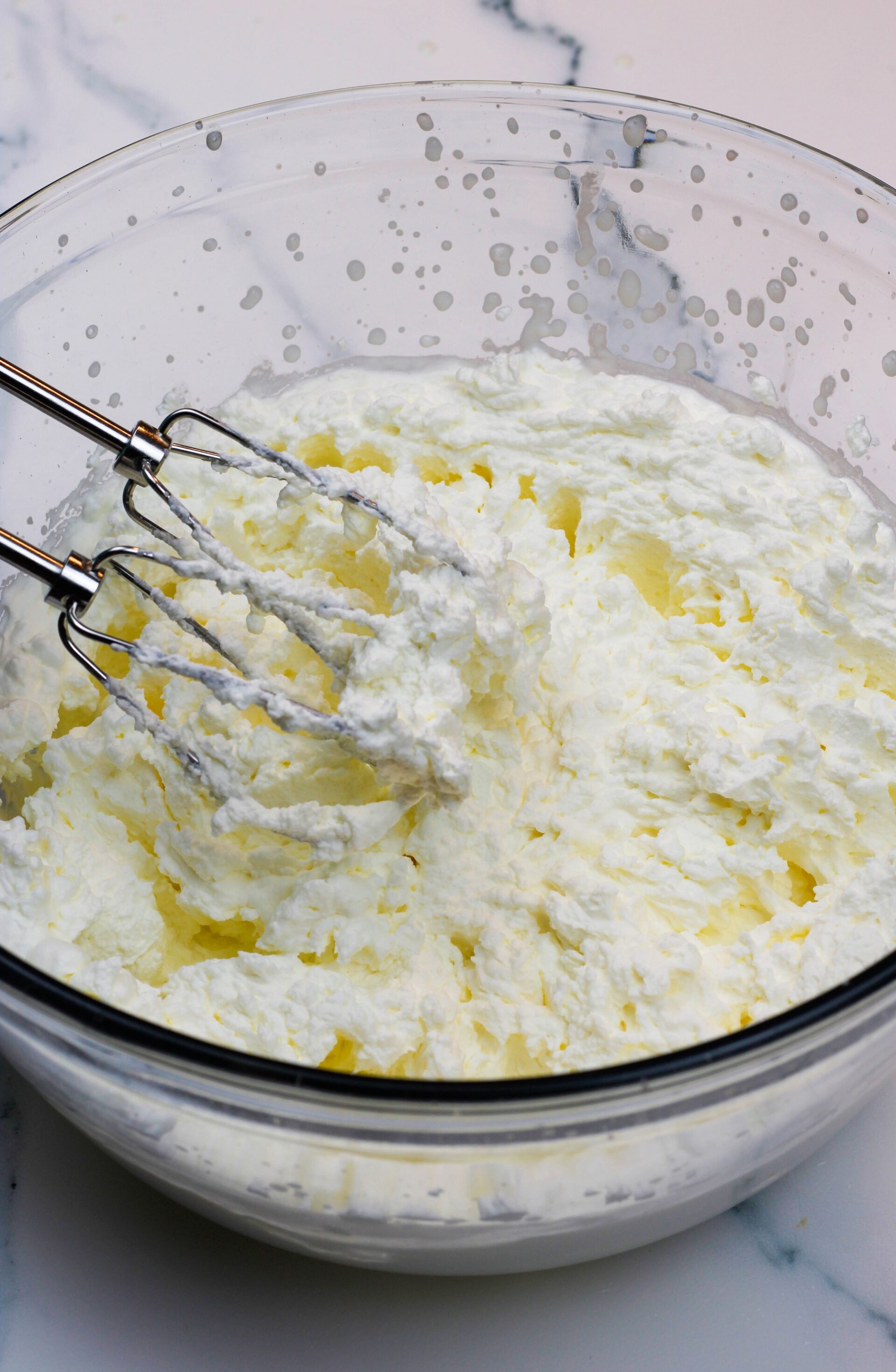 Whipping cream with a hand beater.