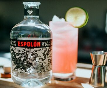 Espolòn Blanco Tequila bottle with pink tequila cocktail