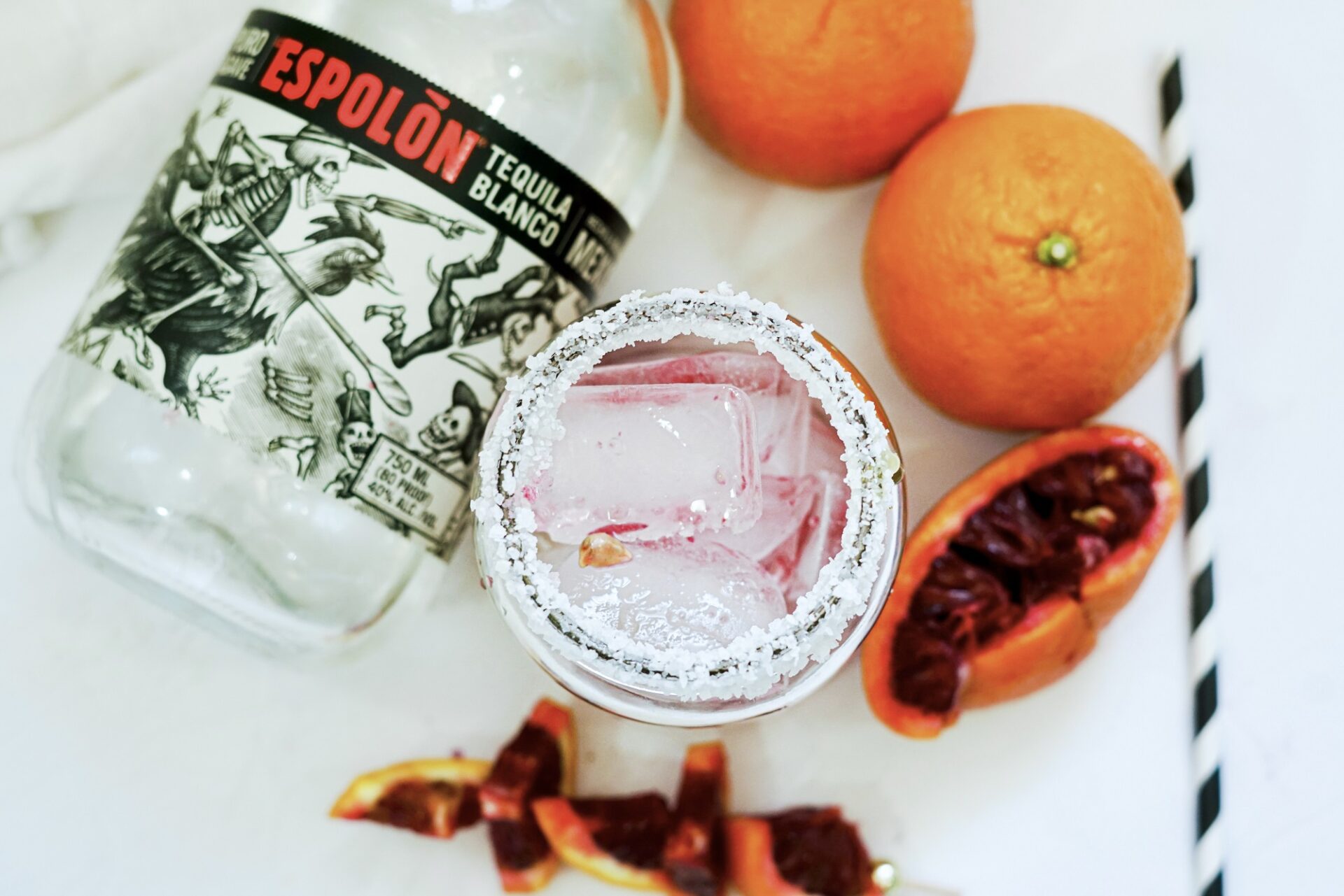 a finished blood orange tequila spritzer with ingredients.