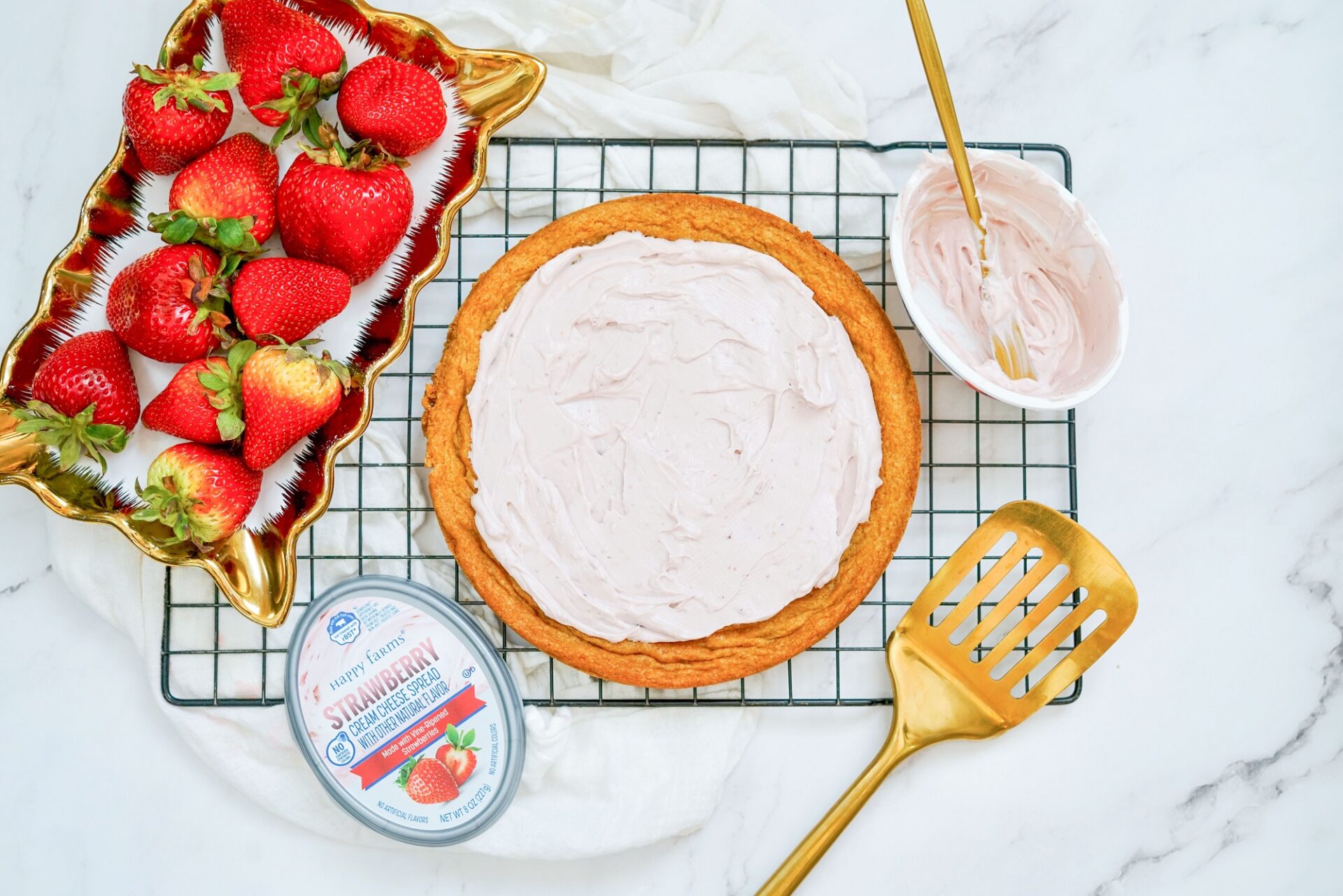 strawberry cream cheese spread over top a baked and cooled cookie crust.