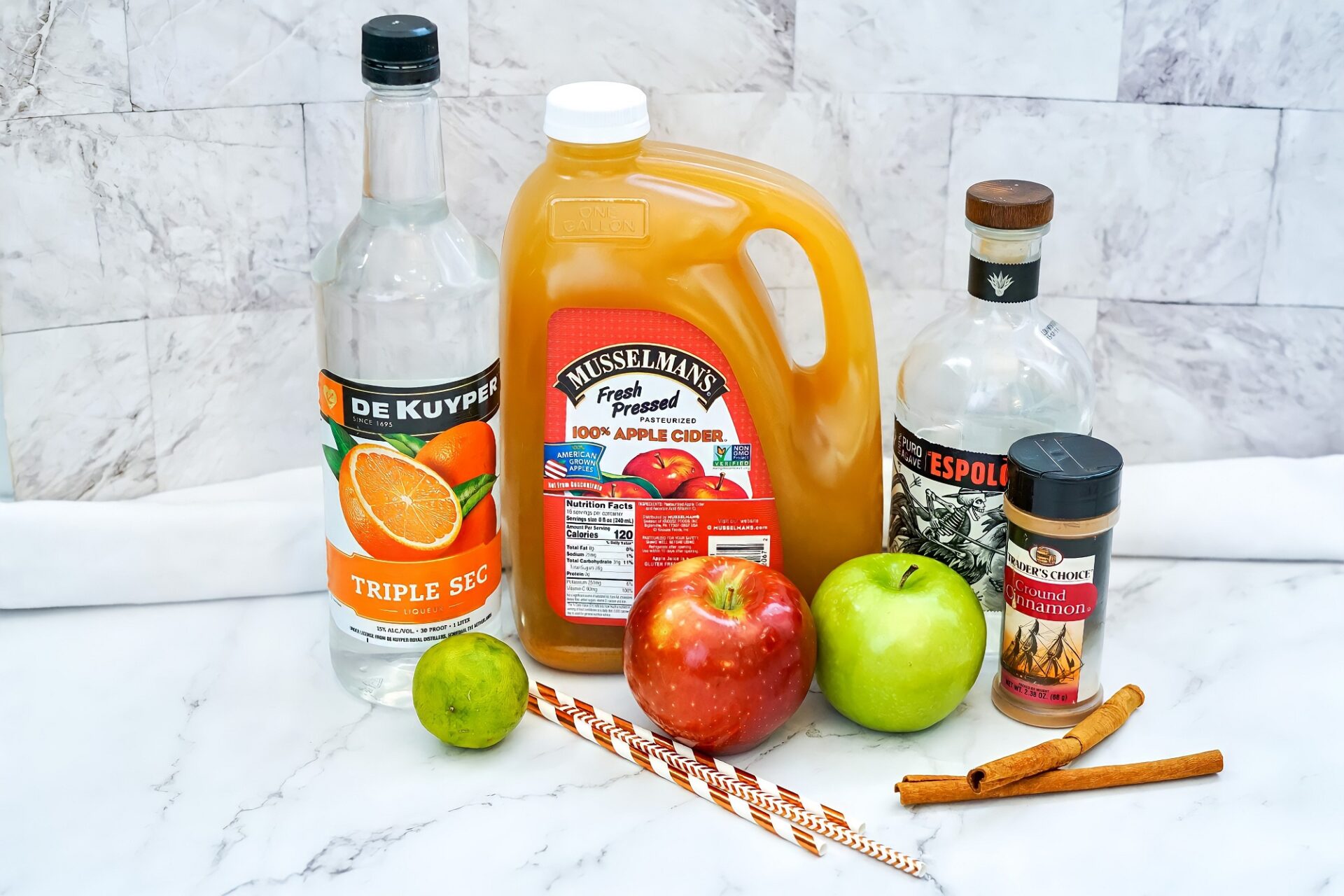 Ingredients for apple cider margarita on a counter.