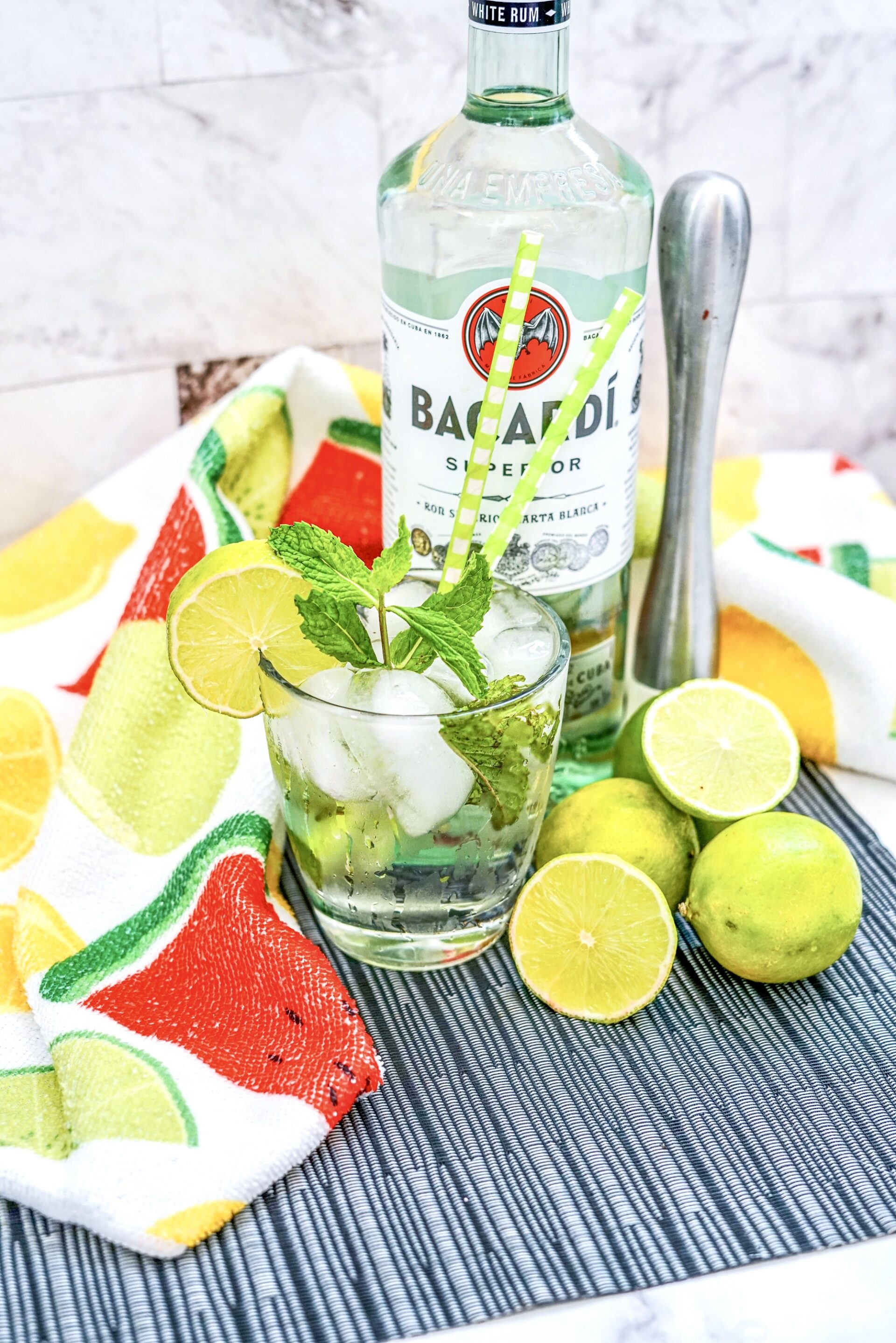 Cuban mojito cocktail on a counter with ingredients.