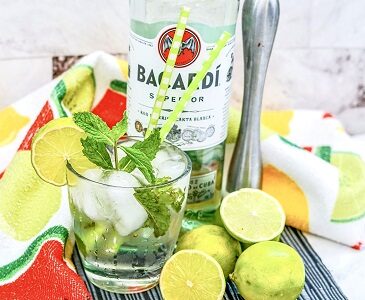 Cuban Mojito in a cocktail glass with mint and lime wedge.