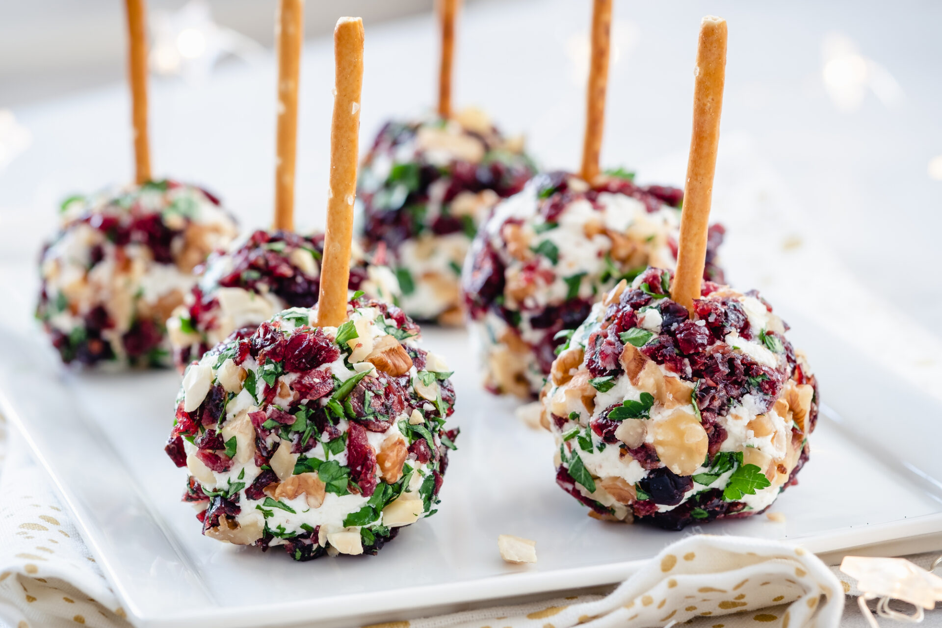 Holiday cheese ball bites on a serving platter.