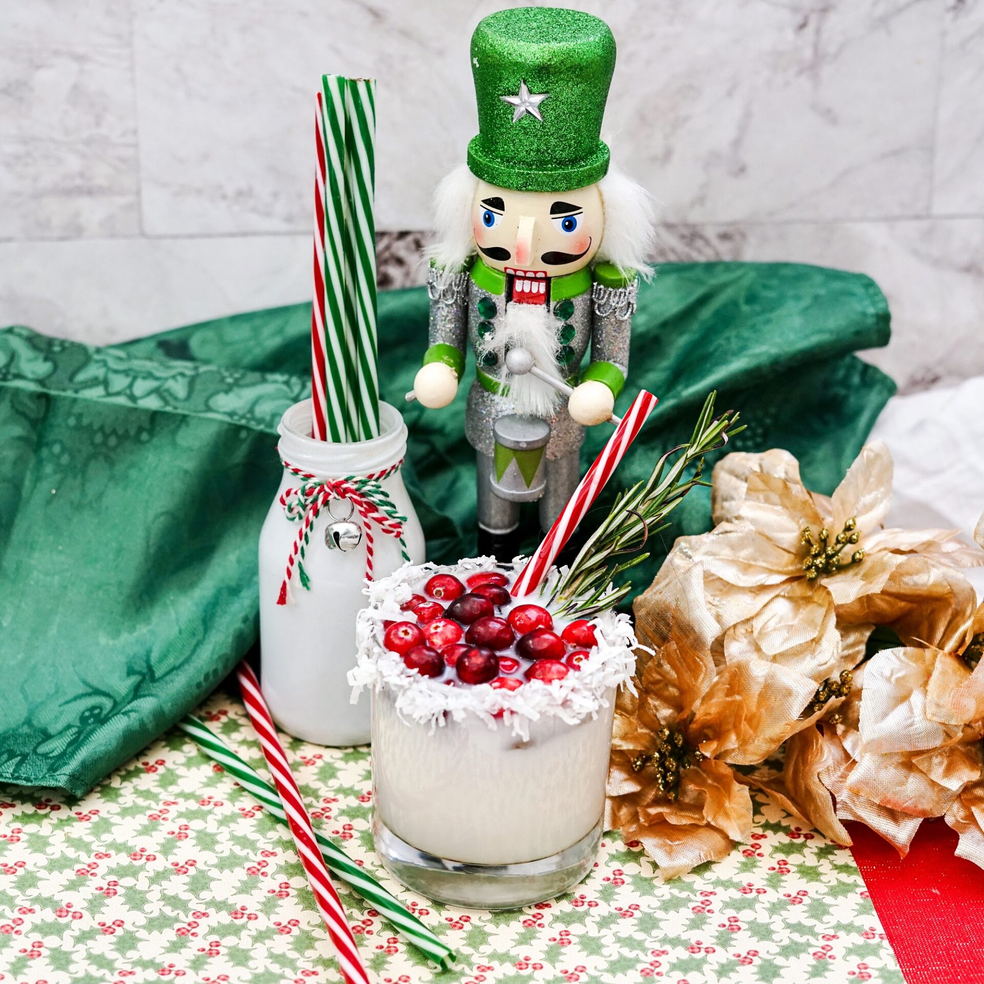Rum coconut milk cocktail on a counter with ingredients and festive decor.