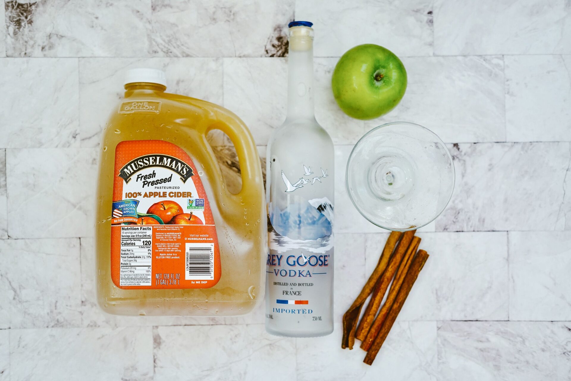 Ingredients for apple cider martini on a counter.