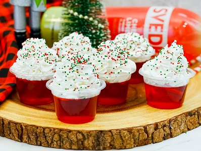 Christmas Jello Shots with whipped cream and sprinkles