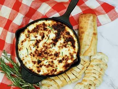Baked Ricotta cheese dip in a cast iron skillet.