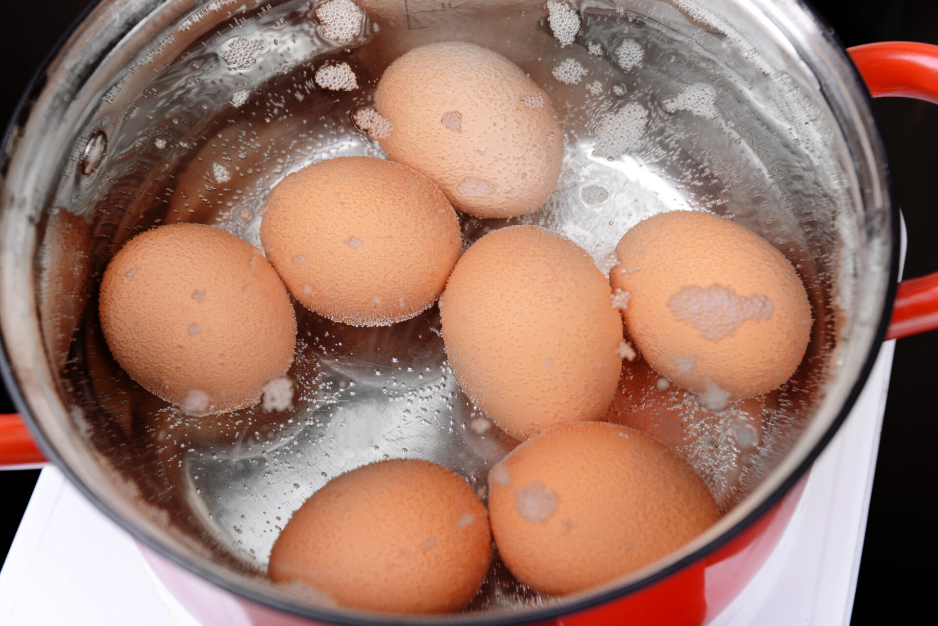 Boiling eggs in hot water.