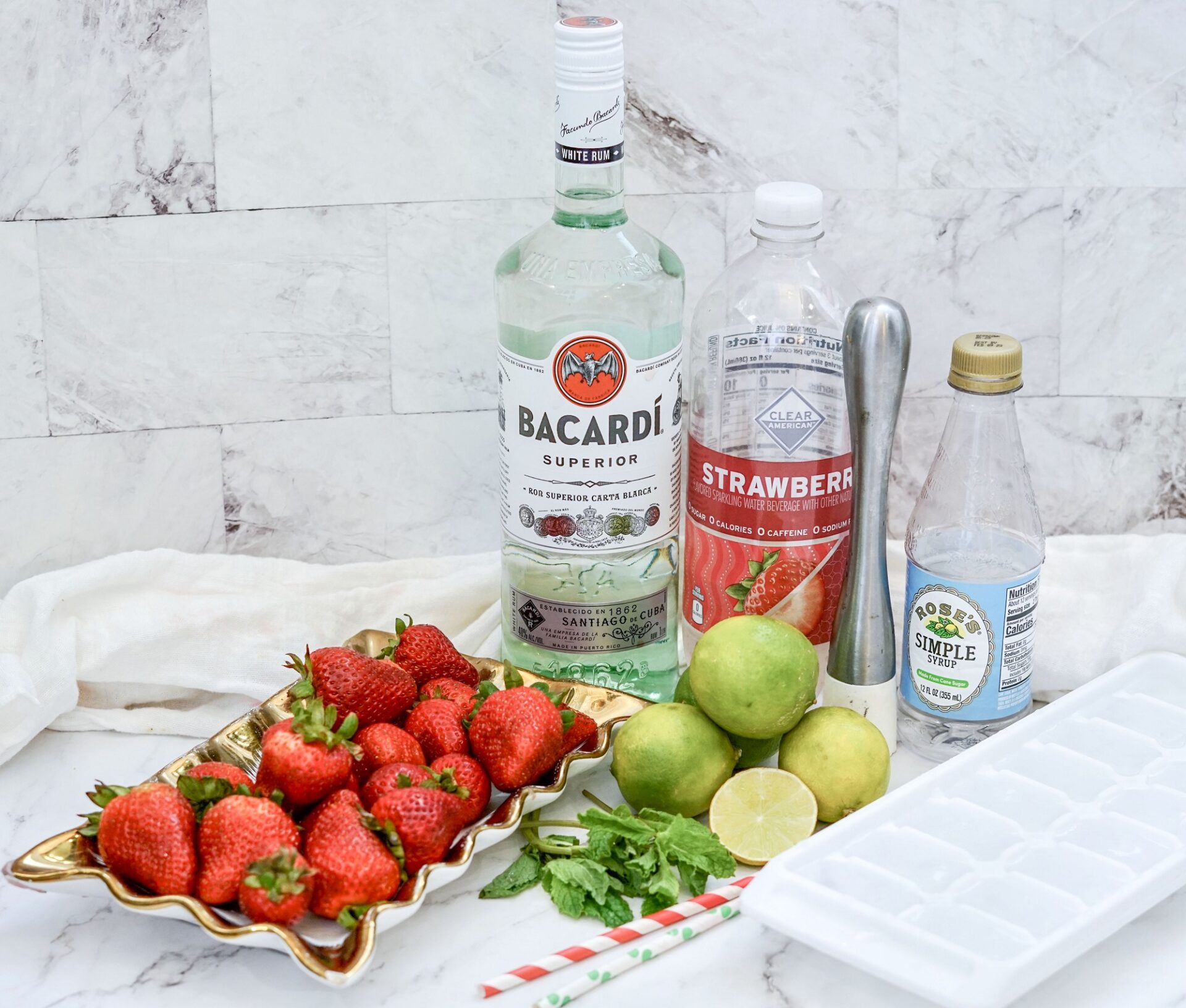 Ingredients for strawberry mojito on a counter.