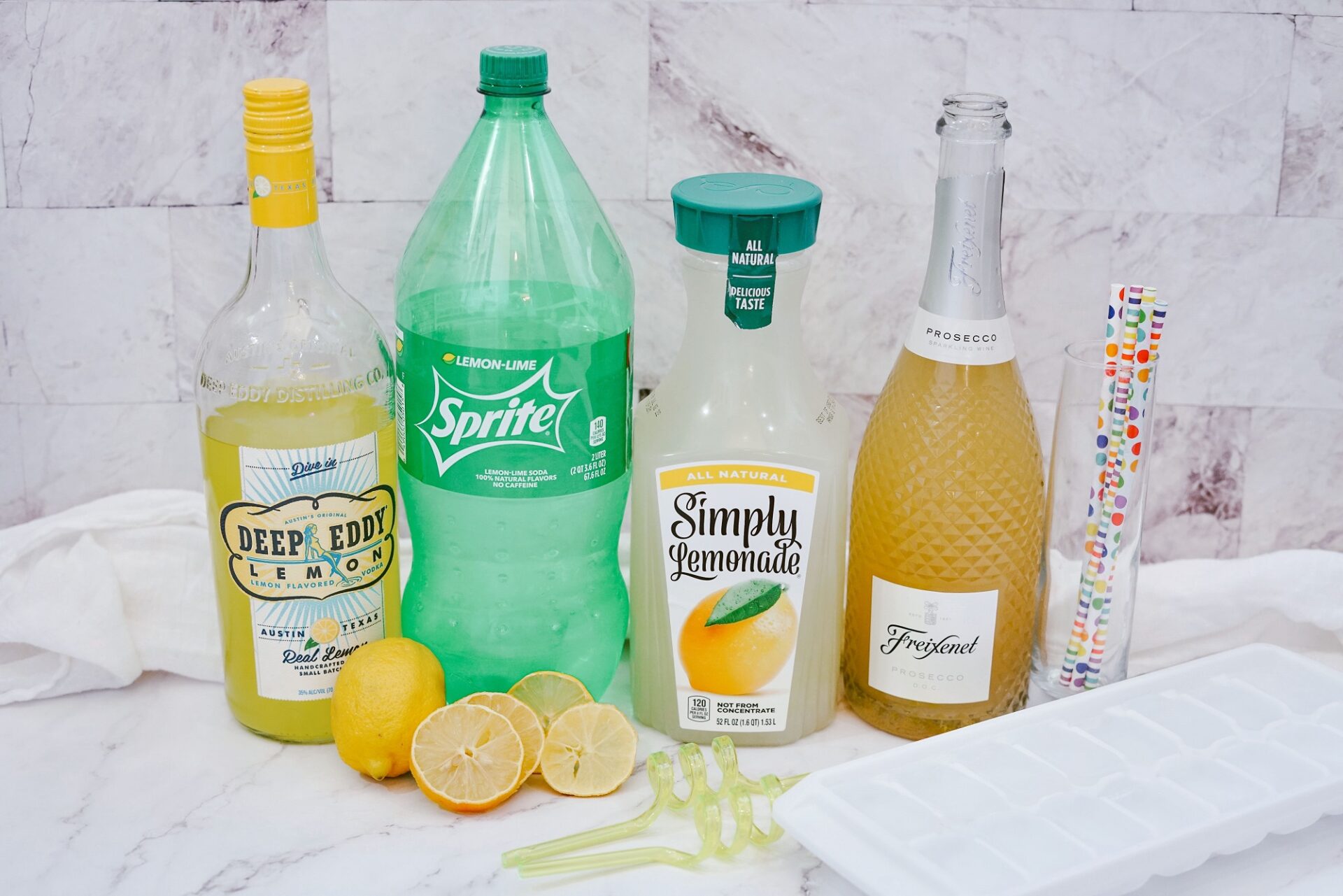 Ingredients for champagne and lemonade cocktail on a counter.