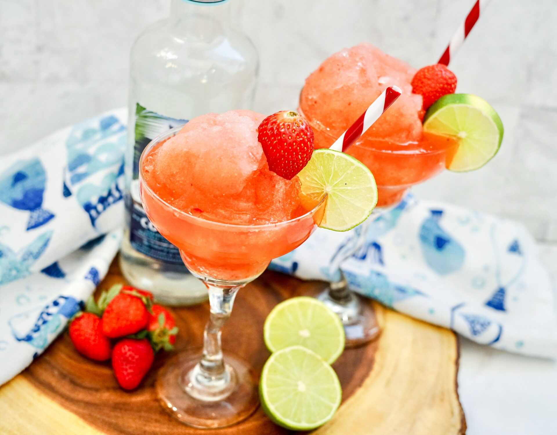 Strawberry Daiquiri in a cocktail glass with lime slice garnish.
