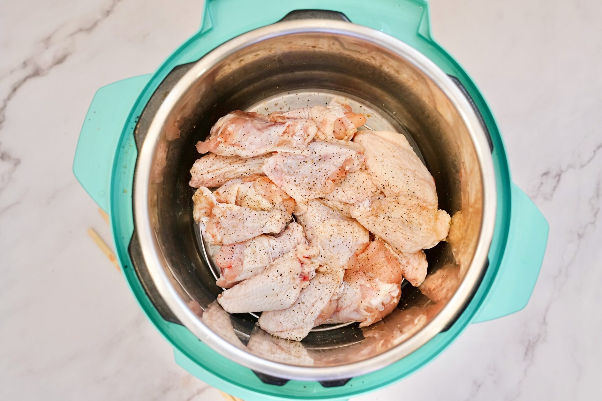 Salted and peppered raw wings in an instant pot.