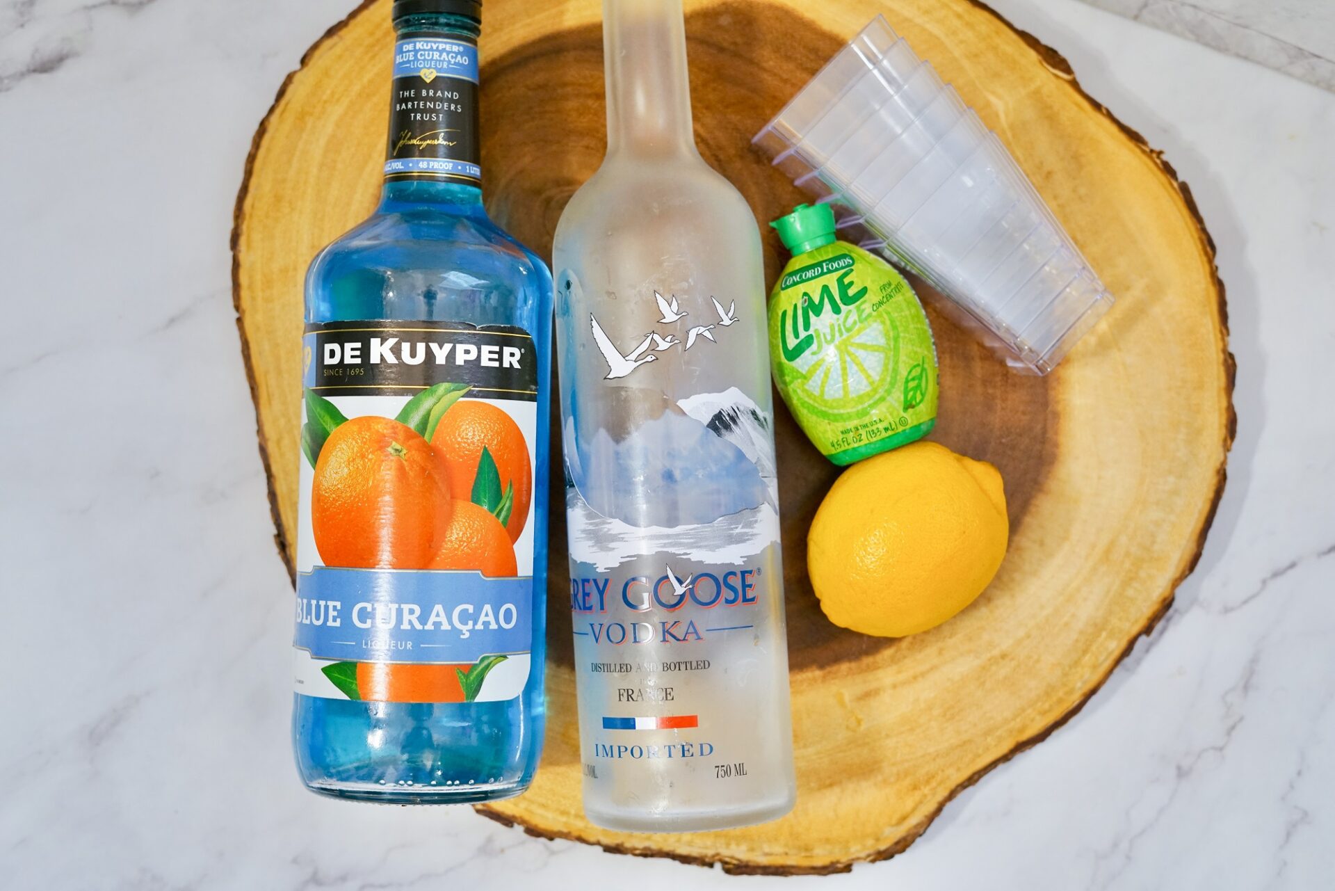 Ingredients for blue kamikaze shot on a counter.