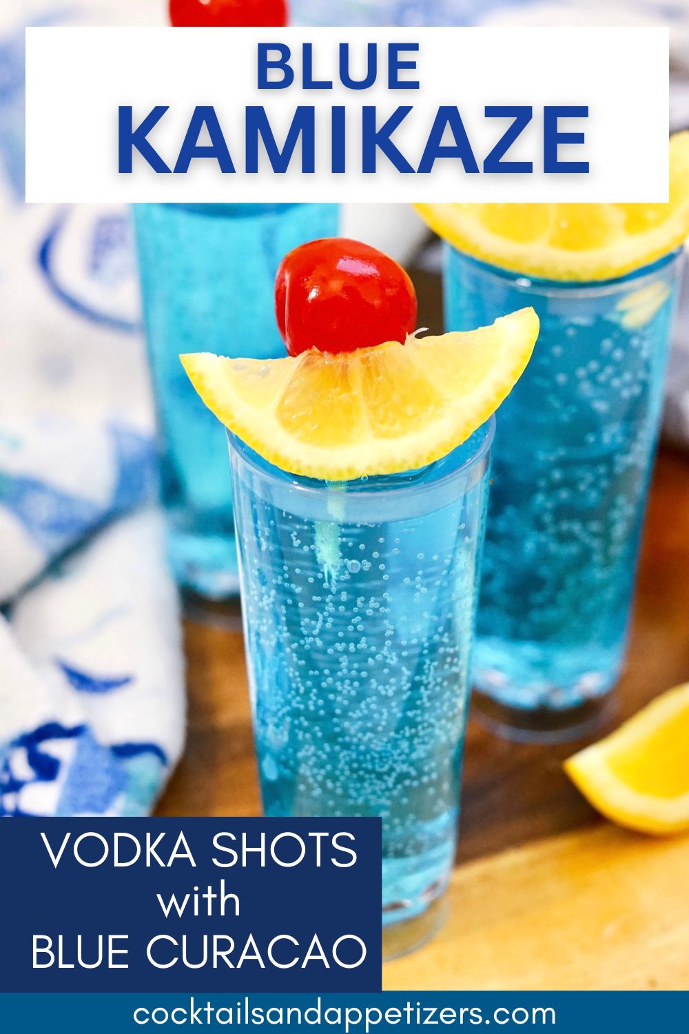 Blue Kamikaze vodka shots in shot glasses on a wood slab