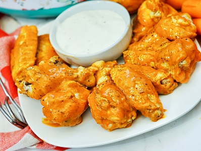 Buffalo Wings made in Instant Pot on a platter with ranch dressing for dipping