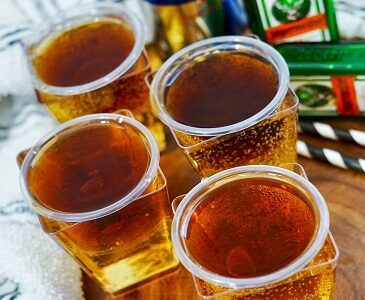 Jager Bomb shots sit in shot glasses inside a glass of Red Bull.