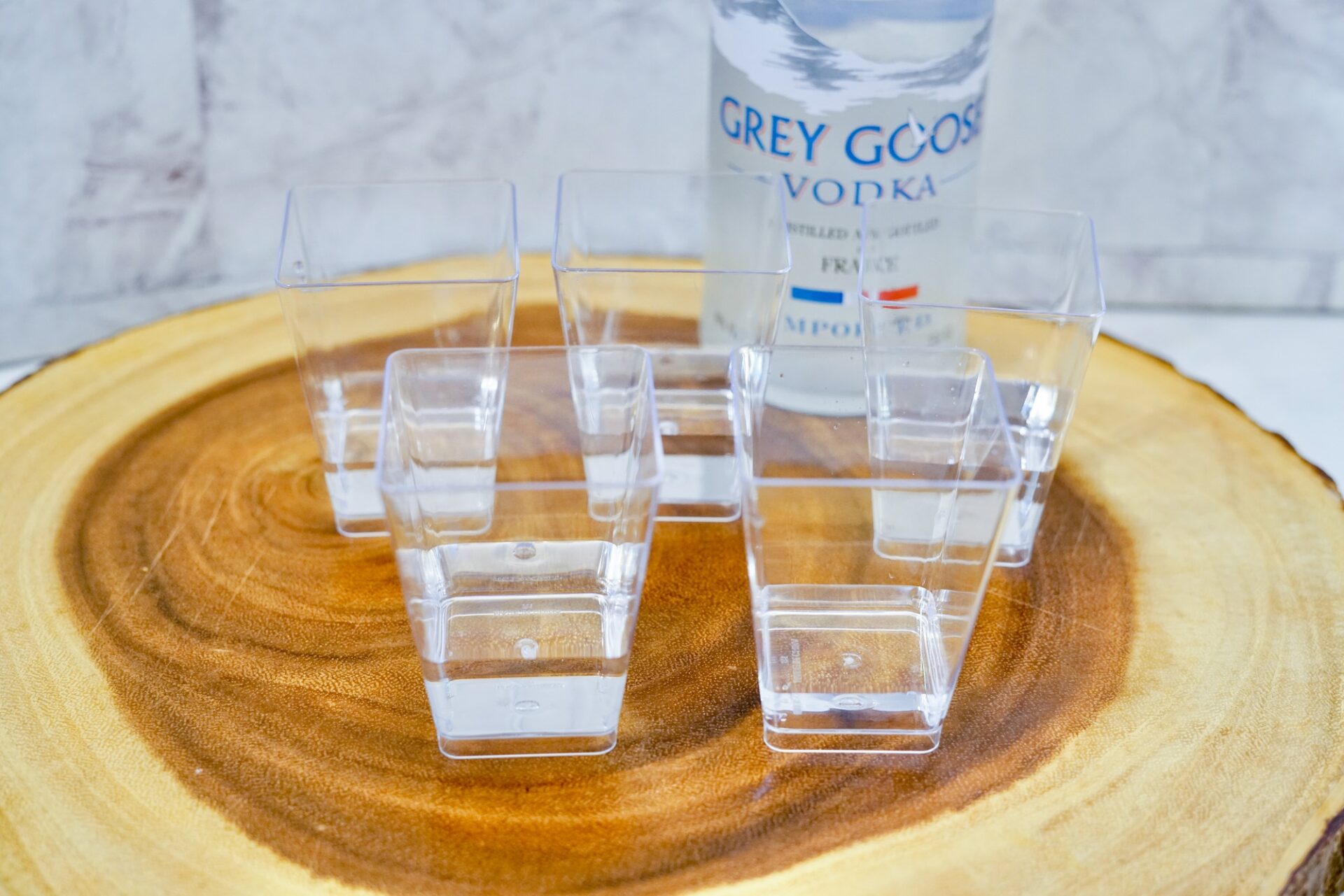 Add vodka to plastic shot glasses.