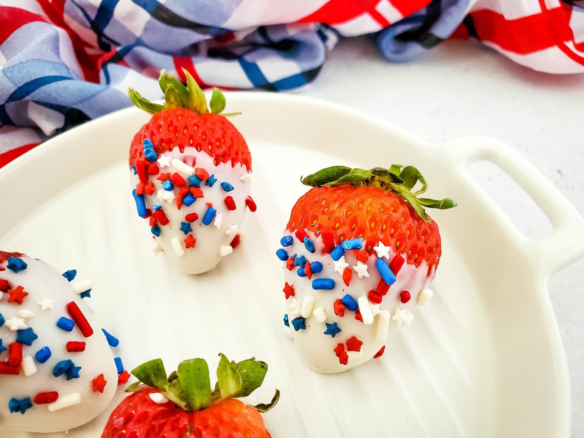 Chocolate Dipped Strawberries with red white and blue sprinkles.