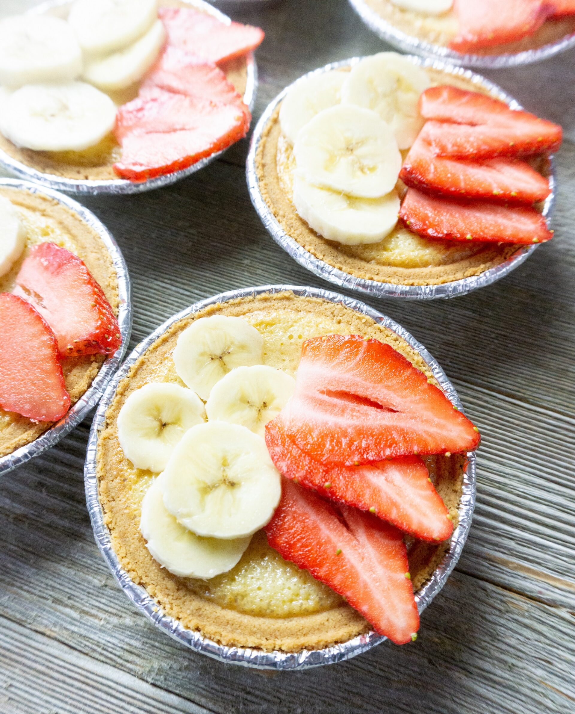 Mini Fruit Tarts with strawberries and banana slices.