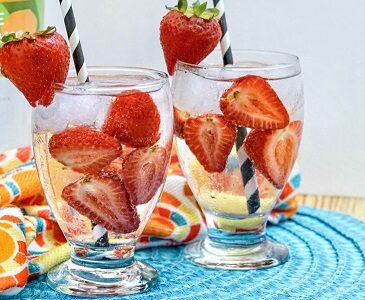 Strawberry Seltzer Vodka drink in glass with strawberries