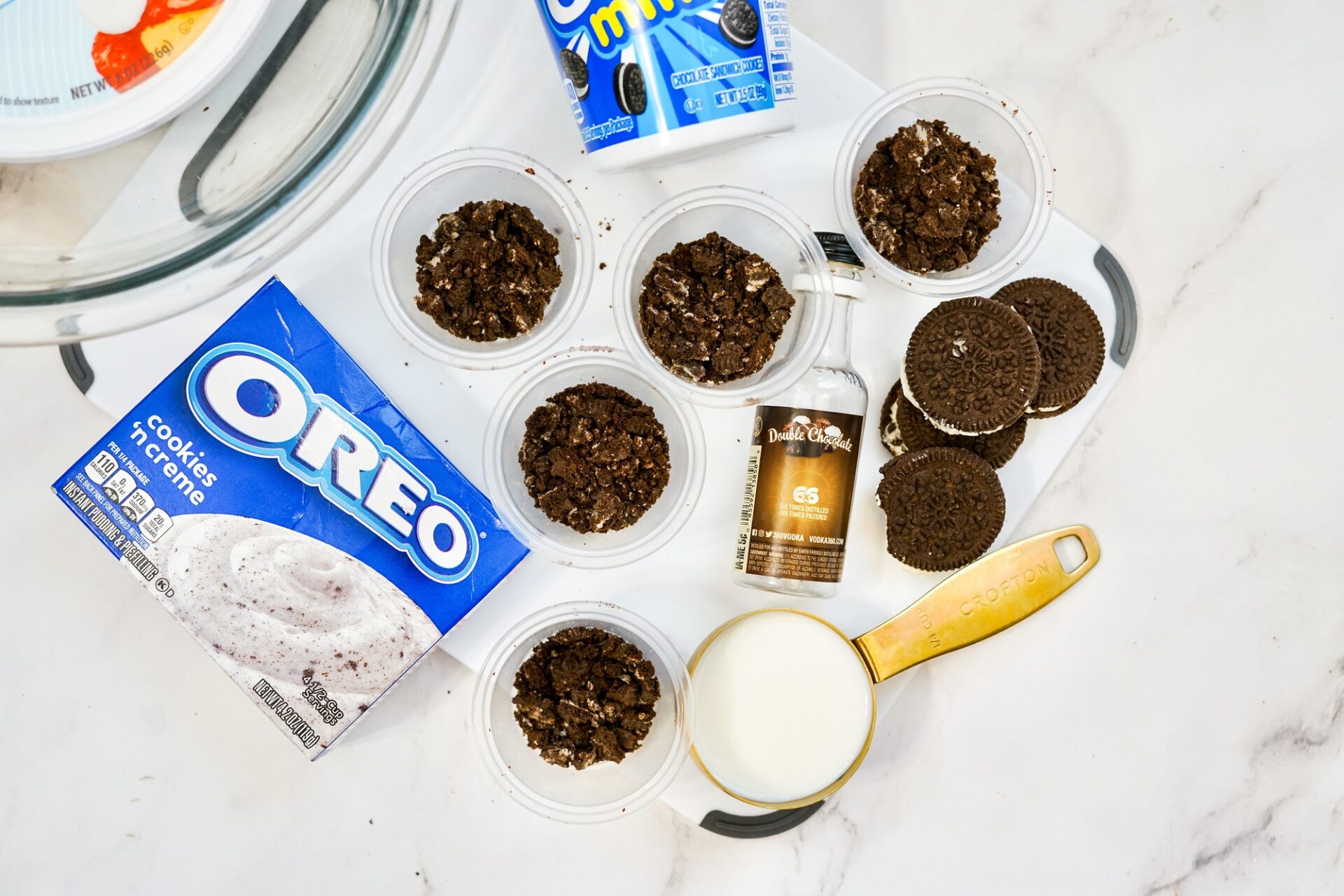 Layering shot cups with crushed Oreos.