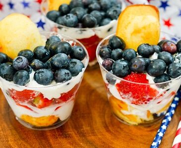 Fruity Twinkie Cake dessert cups with berries and whipped cream